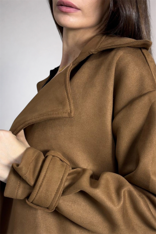 Close-up of a brown coat with a neutral background