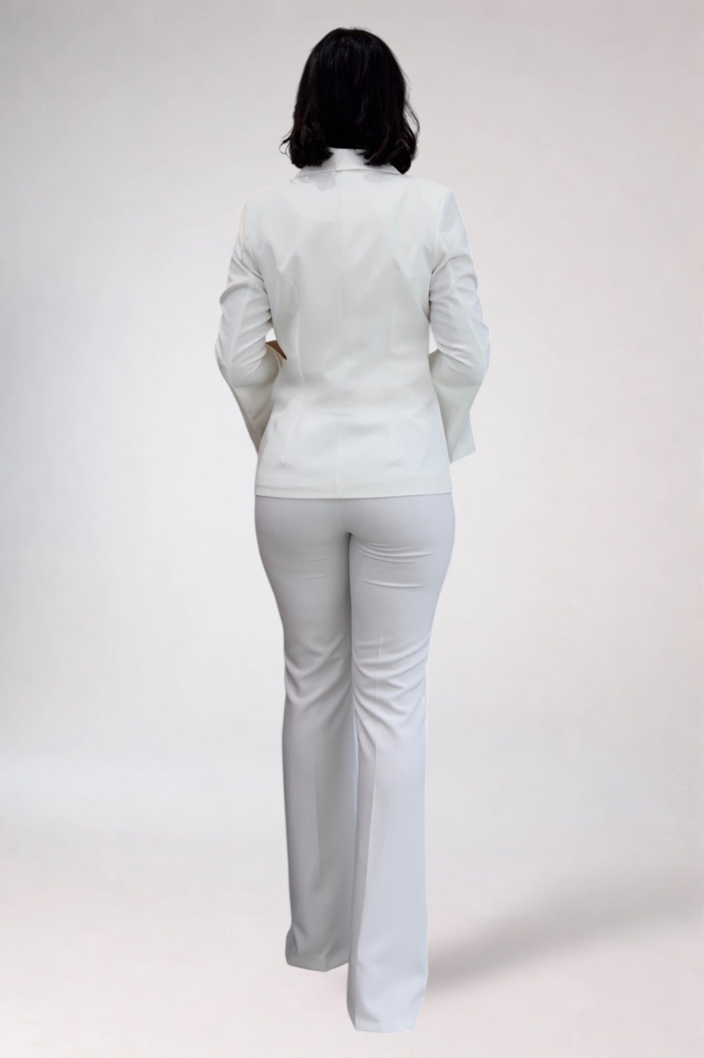 Person wearing a white outfit on a plain background
