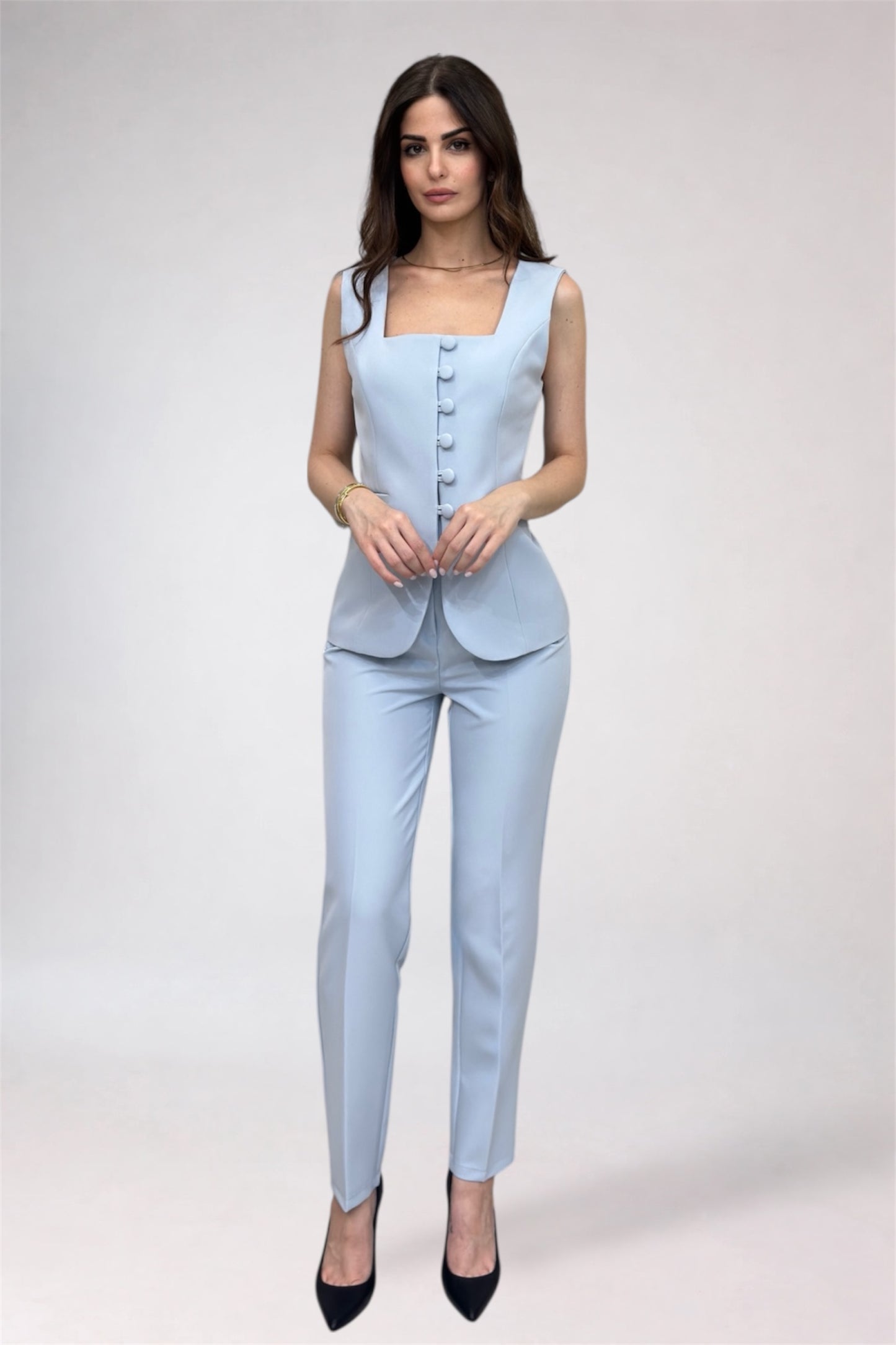 Woman wearing a light blue suit with a white background