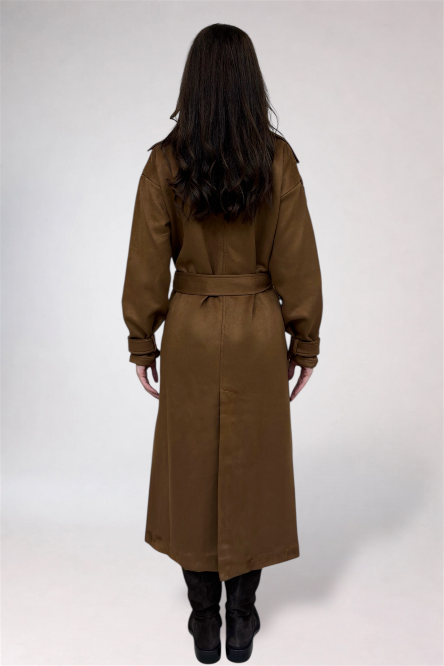 Woman wearing a brown trench coat on a white background