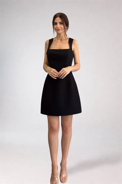 Woman wearing a black sleeveless dress on a white background