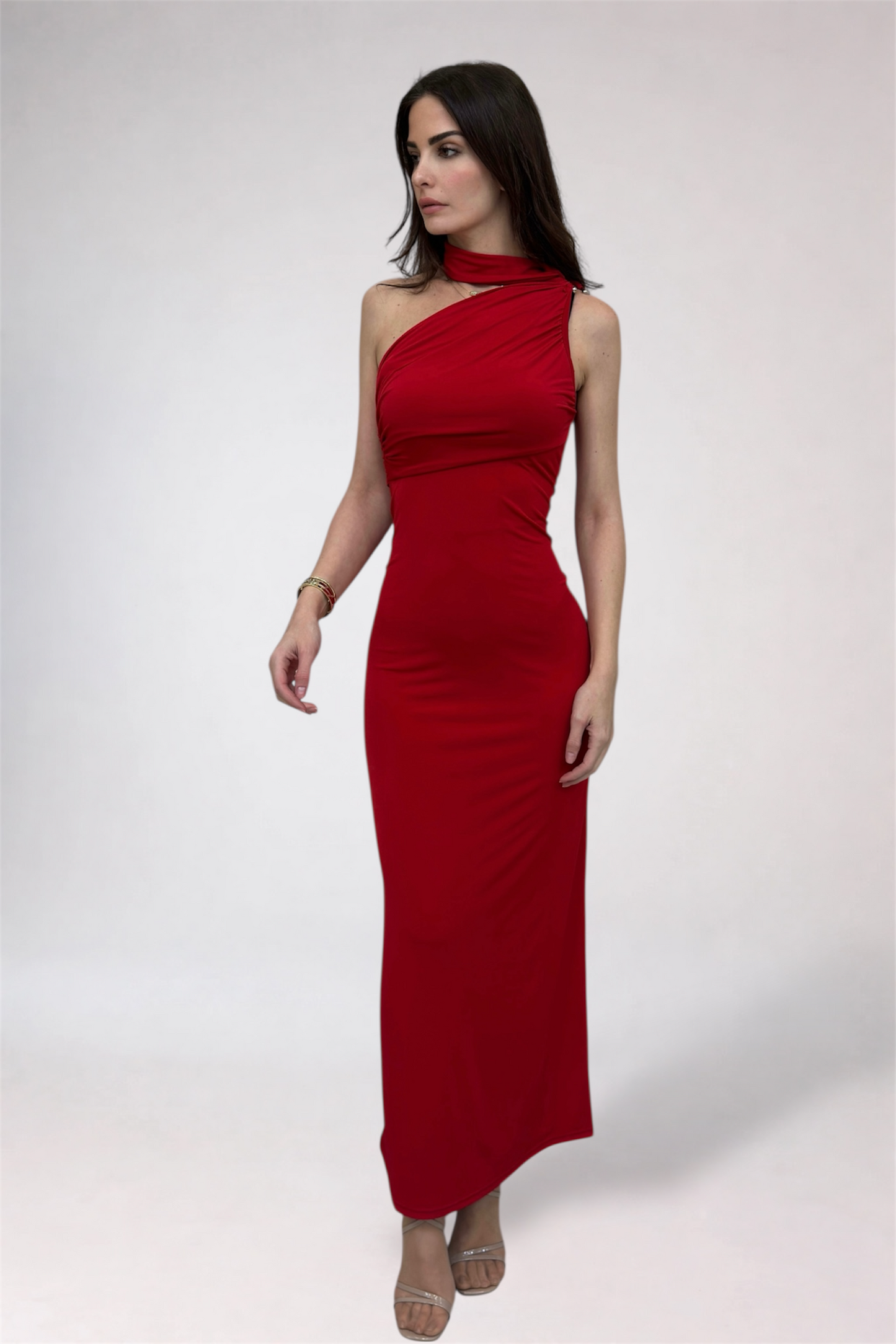 Woman wearing a red one-shoulder dress on a white background