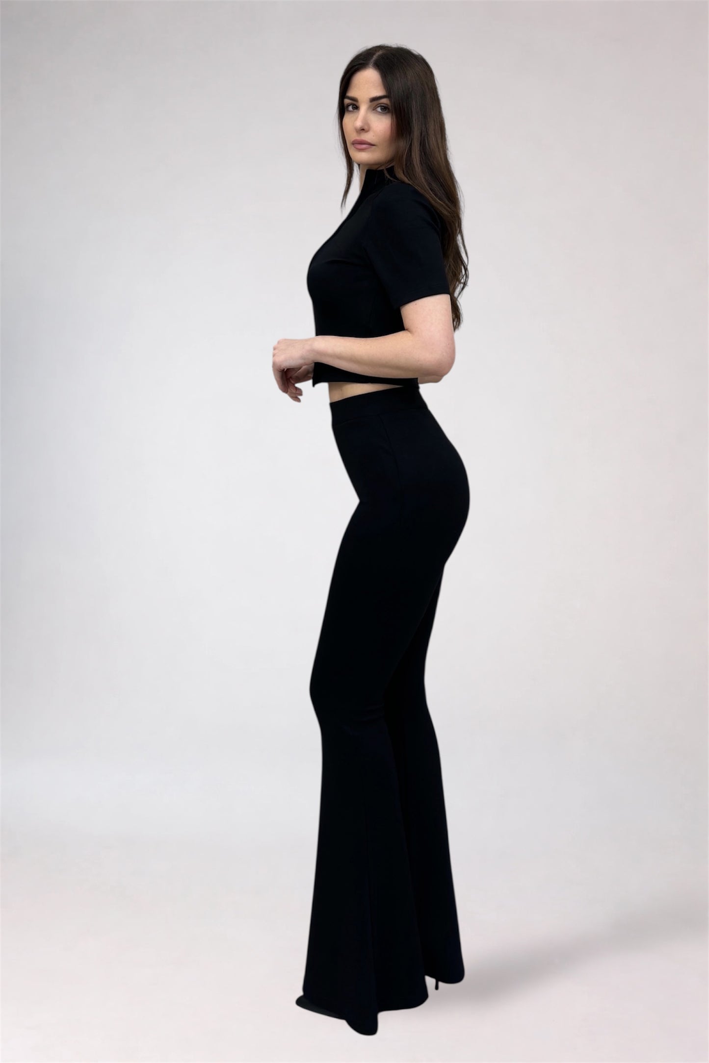 Woman wearing a black outfit on a white background