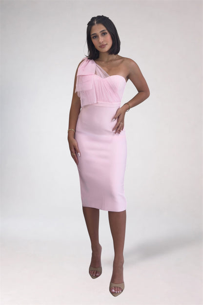 Woman wearing a pink one-shoulder dress on a white background