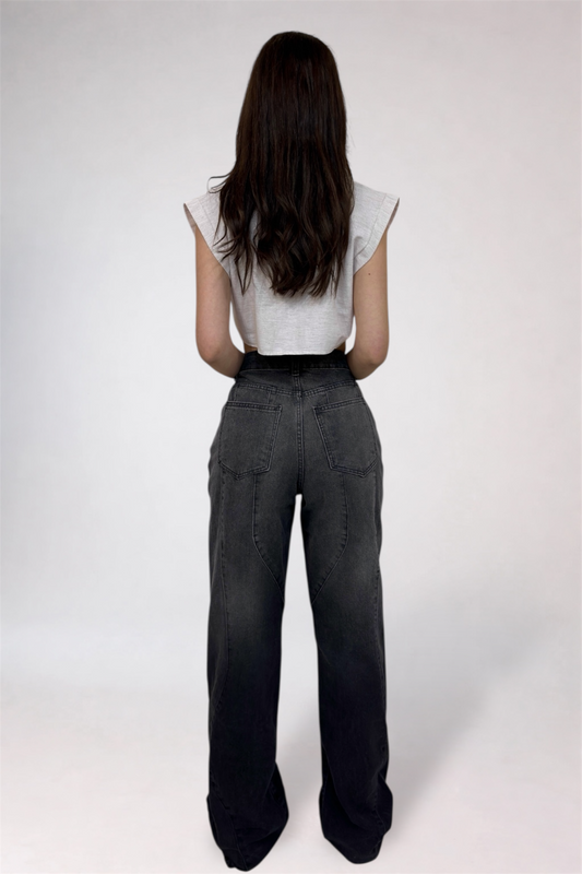 Person wearing a white top and dark gray pants on a white background