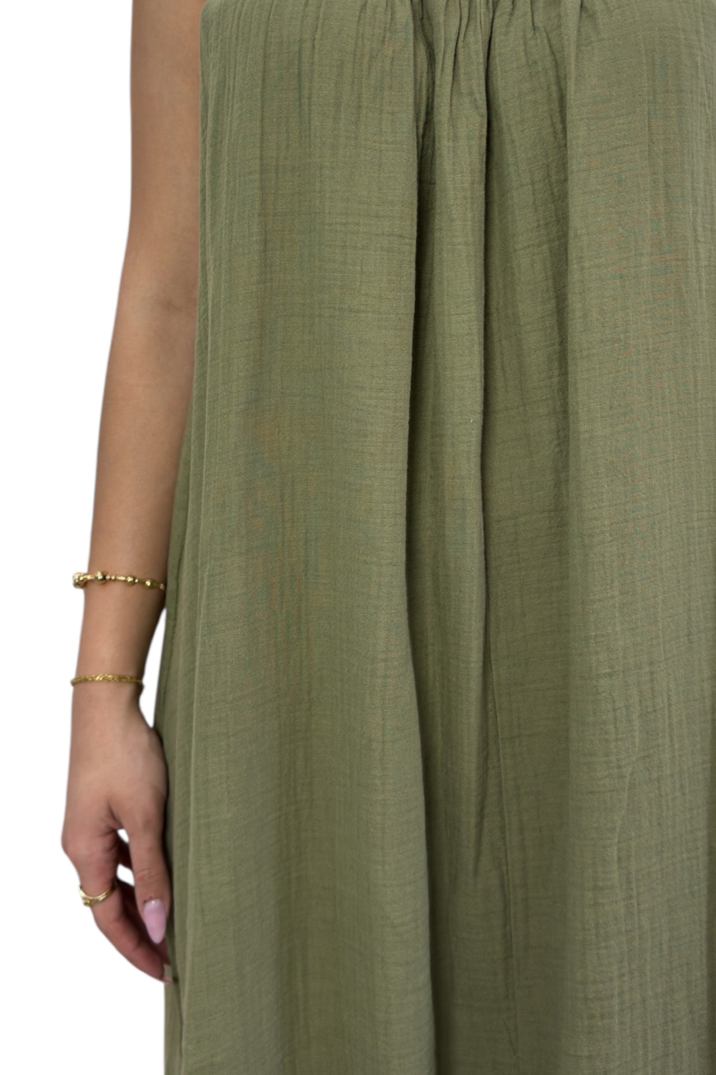 Green fabric with a person wearing it, showing texture and color.