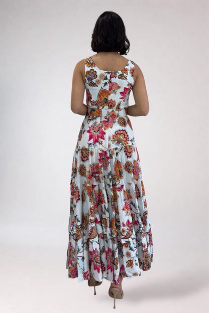 Woman wearing a floral dress from behind on a plain background