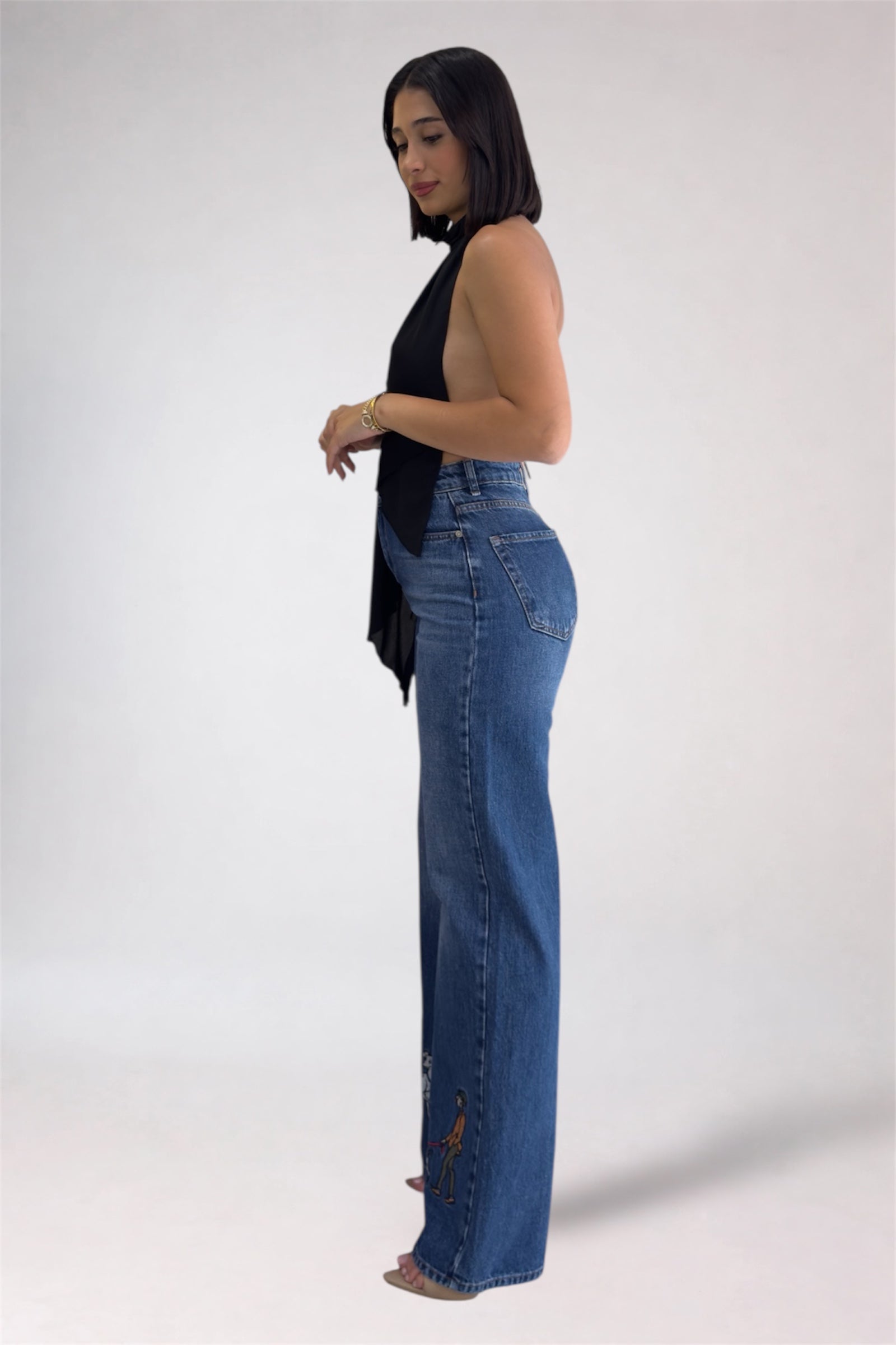 Woman wearing blue jeans on a white background
