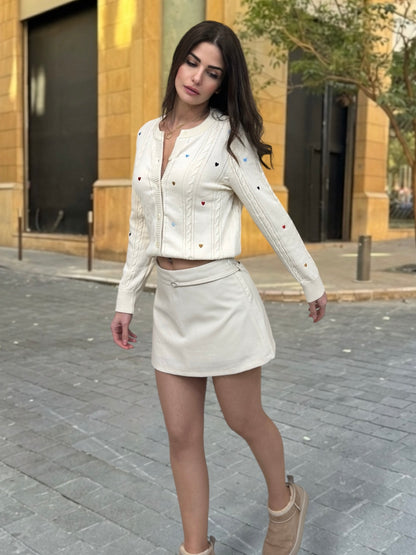 Woman in a white outfit walking on a street.