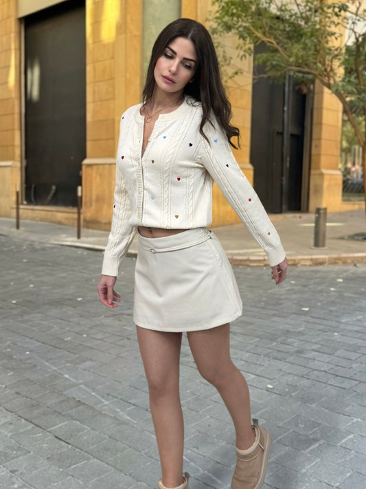 Woman in a white outfit walking on a street.