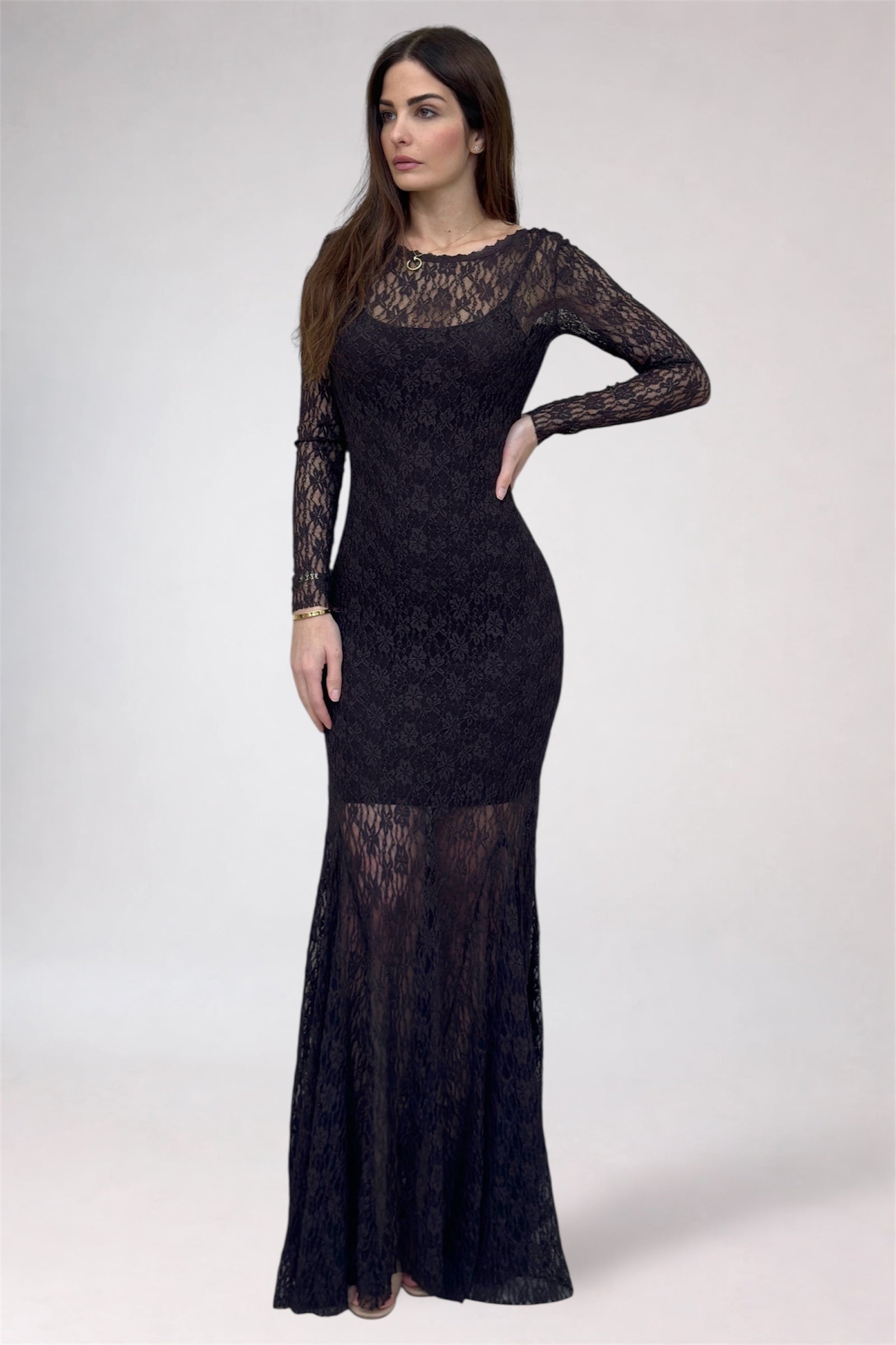 Woman wearing a black lace dress on a white background