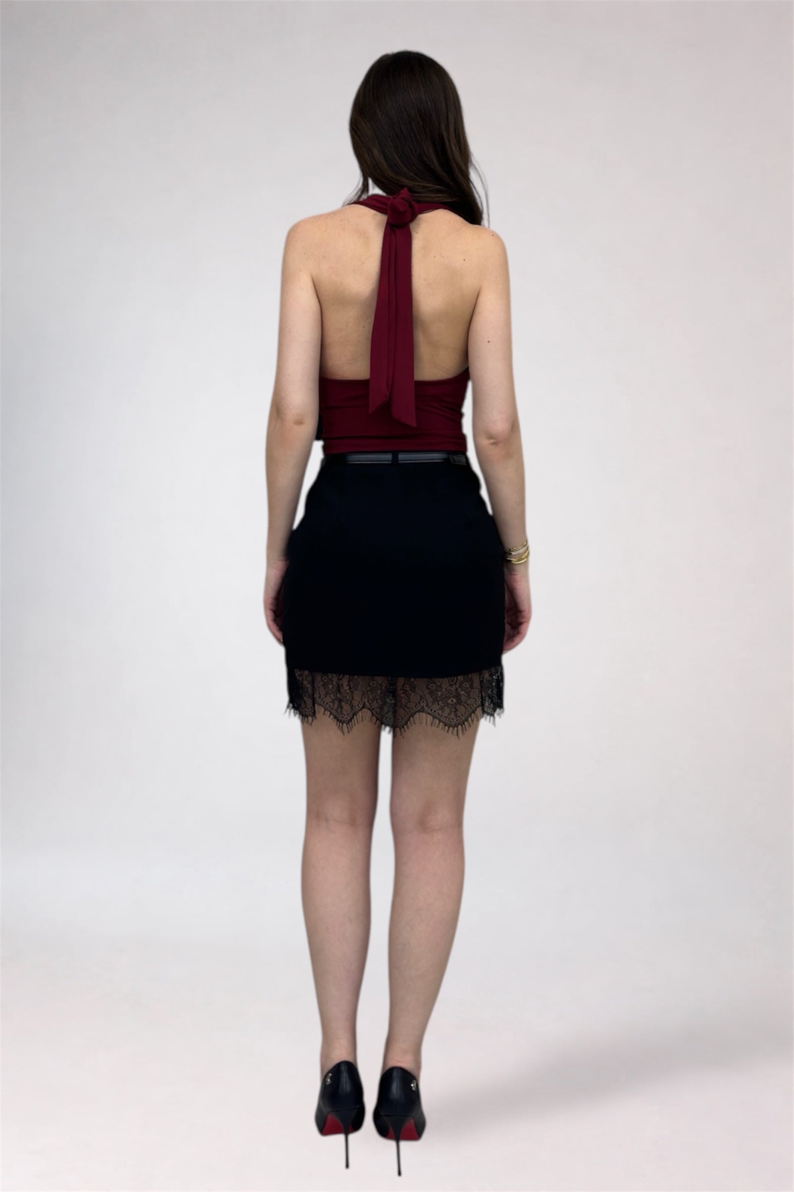 Person wearing a black dress with a red top on a white background