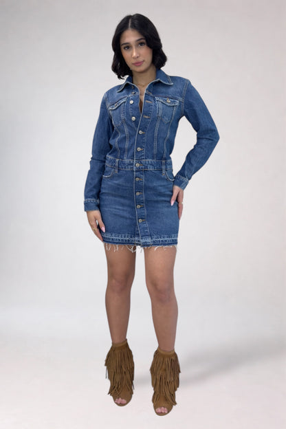 Woman wearing a denim dress with fringed brown boots on a white background