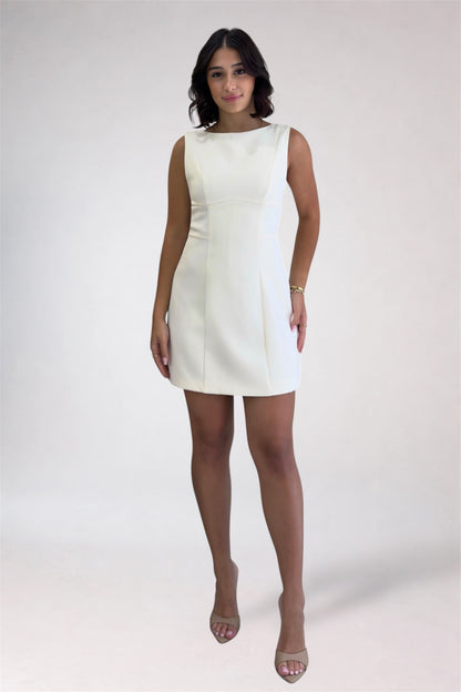 Woman wearing a white dress on a plain background