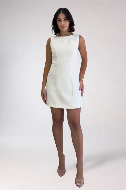 Woman wearing a white dress on a plain background