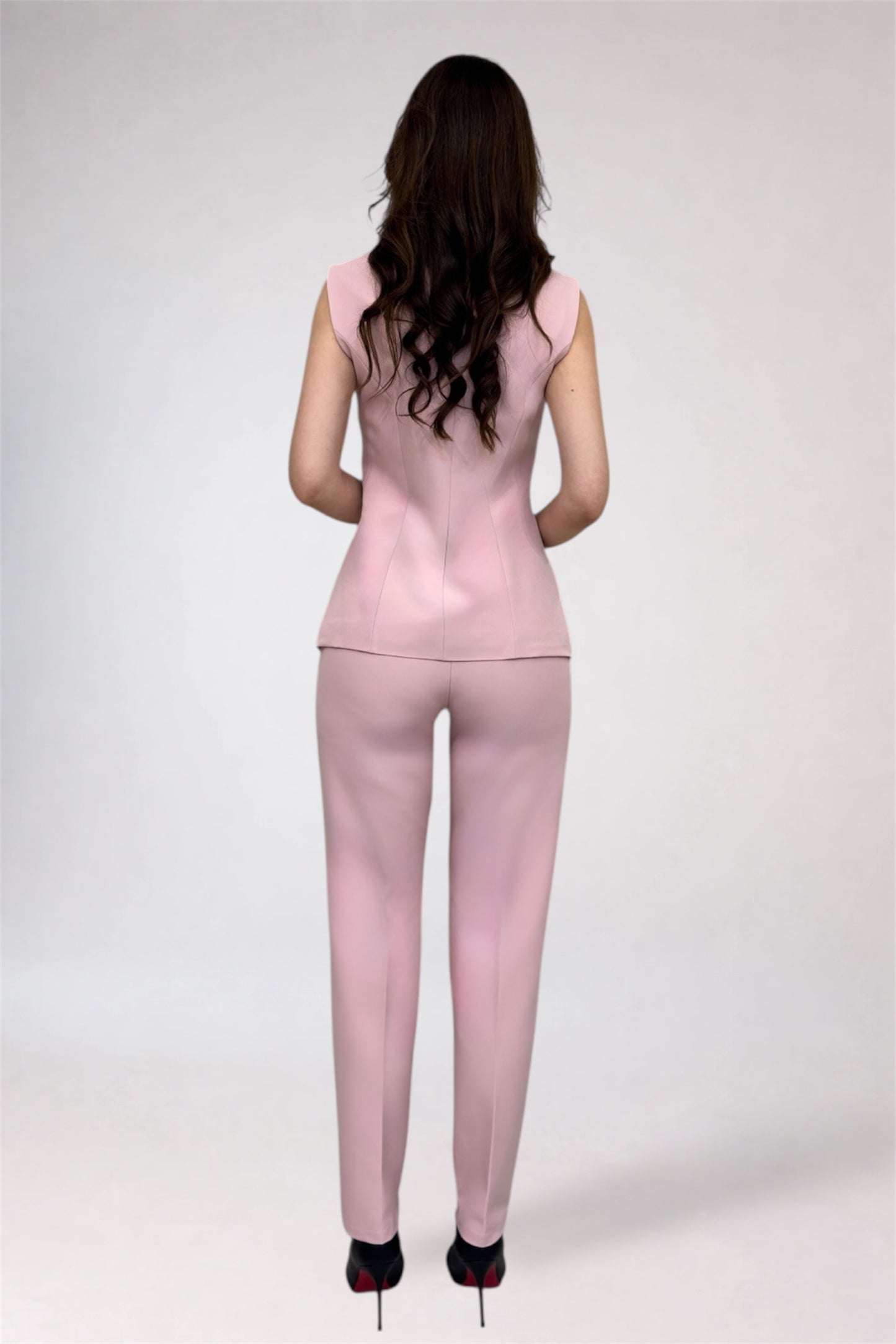 Woman wearing a pink outfit on a white background