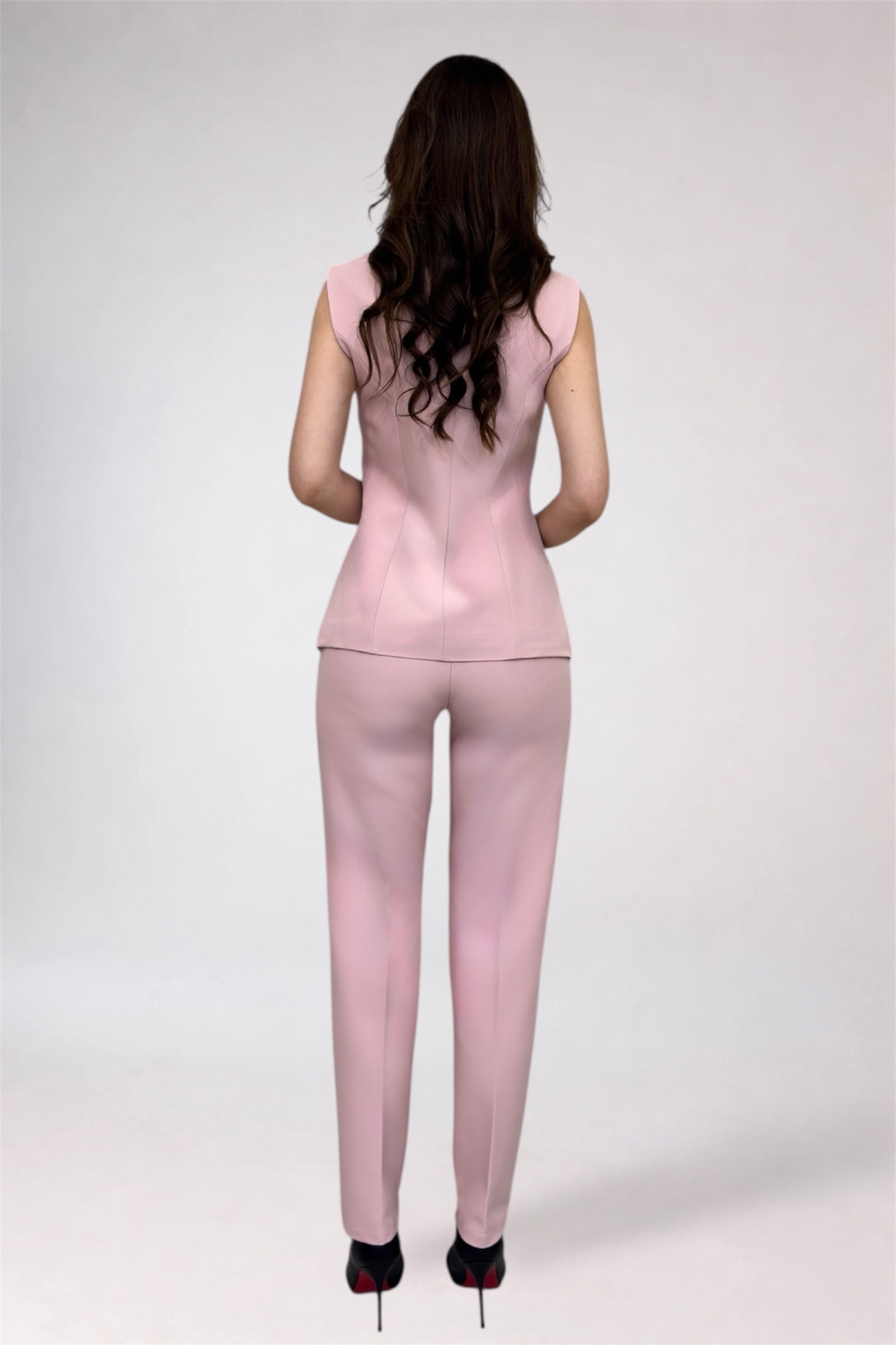 Woman wearing a pink outfit on a white background