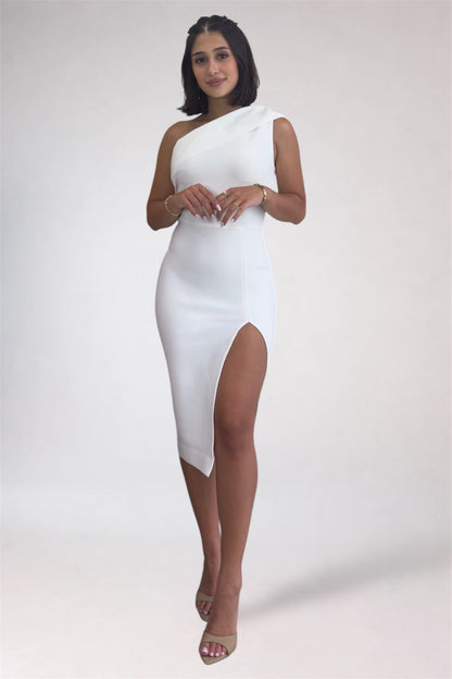 Woman wearing a white one-shoulder dress with a slit on a plain background