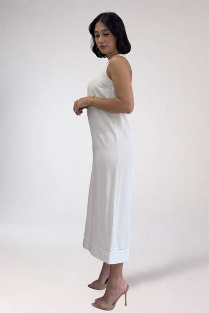 Woman wearing a white dress against a plain background