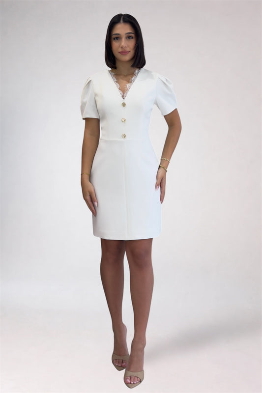 Woman wearing a white dress with buttons on a white background