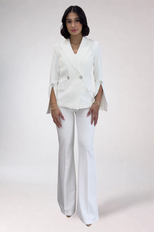Woman wearing a white suit on a plain background