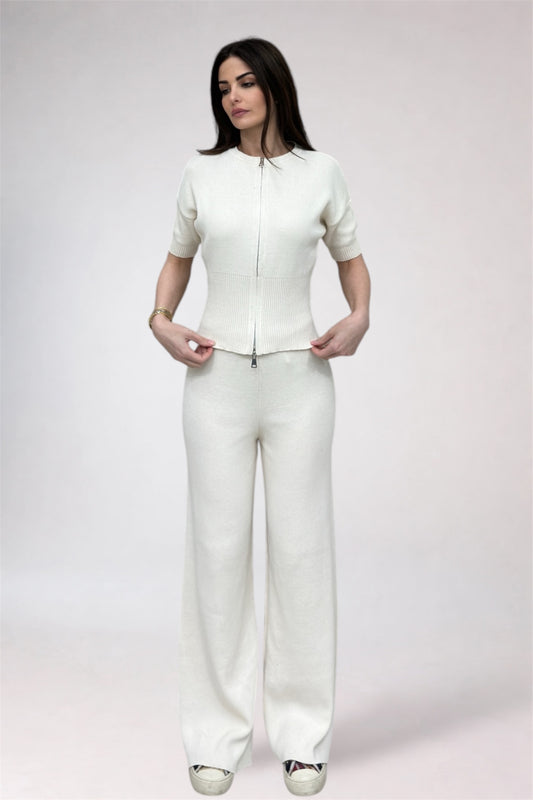 Woman wearing a white outfit on a plain background
