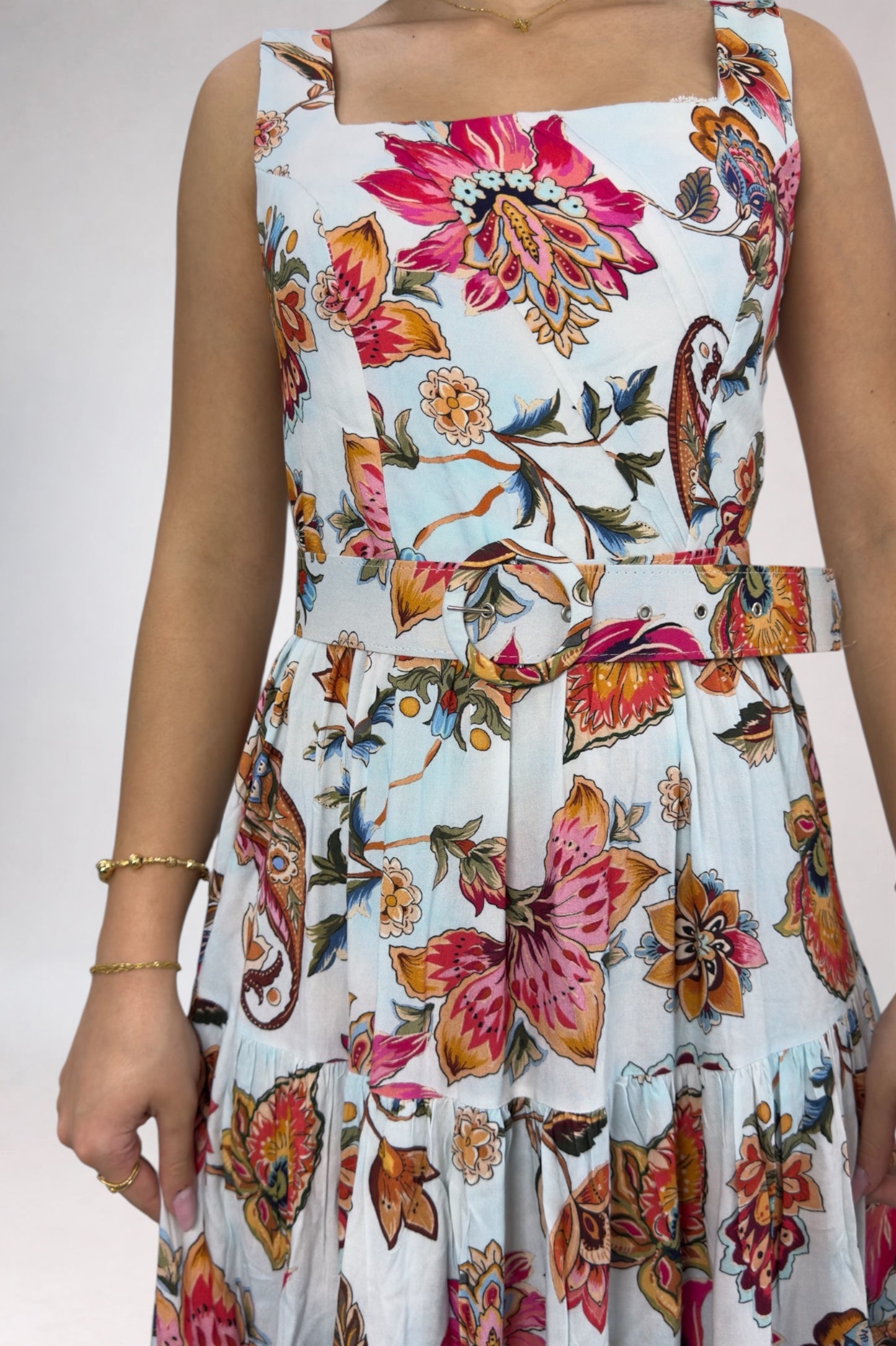 Floral dress with colorful patterns on a plain background