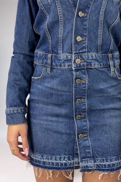 Blue denim dress with buttons on a plain background