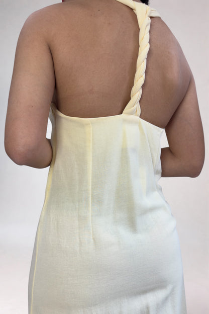 Light green sleeveless dress with thin straps on a plain background