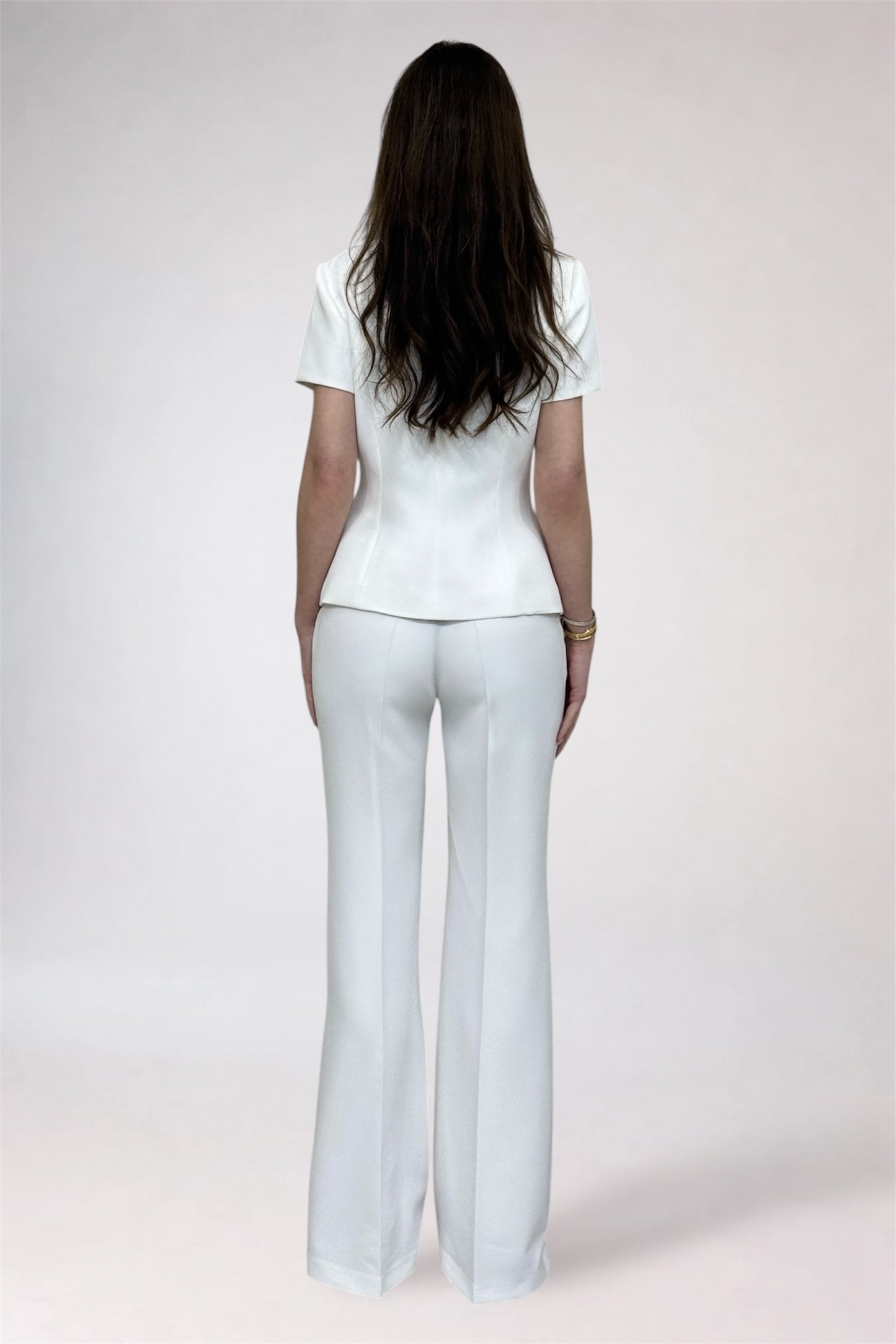 Person wearing a white outfit on a plain background