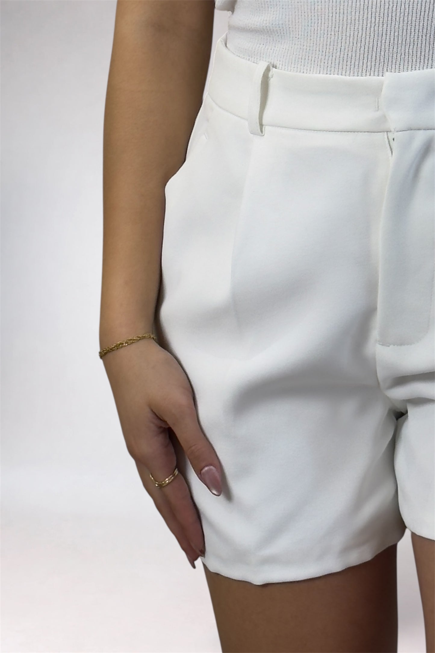 White shorts worn by a person on a plain background