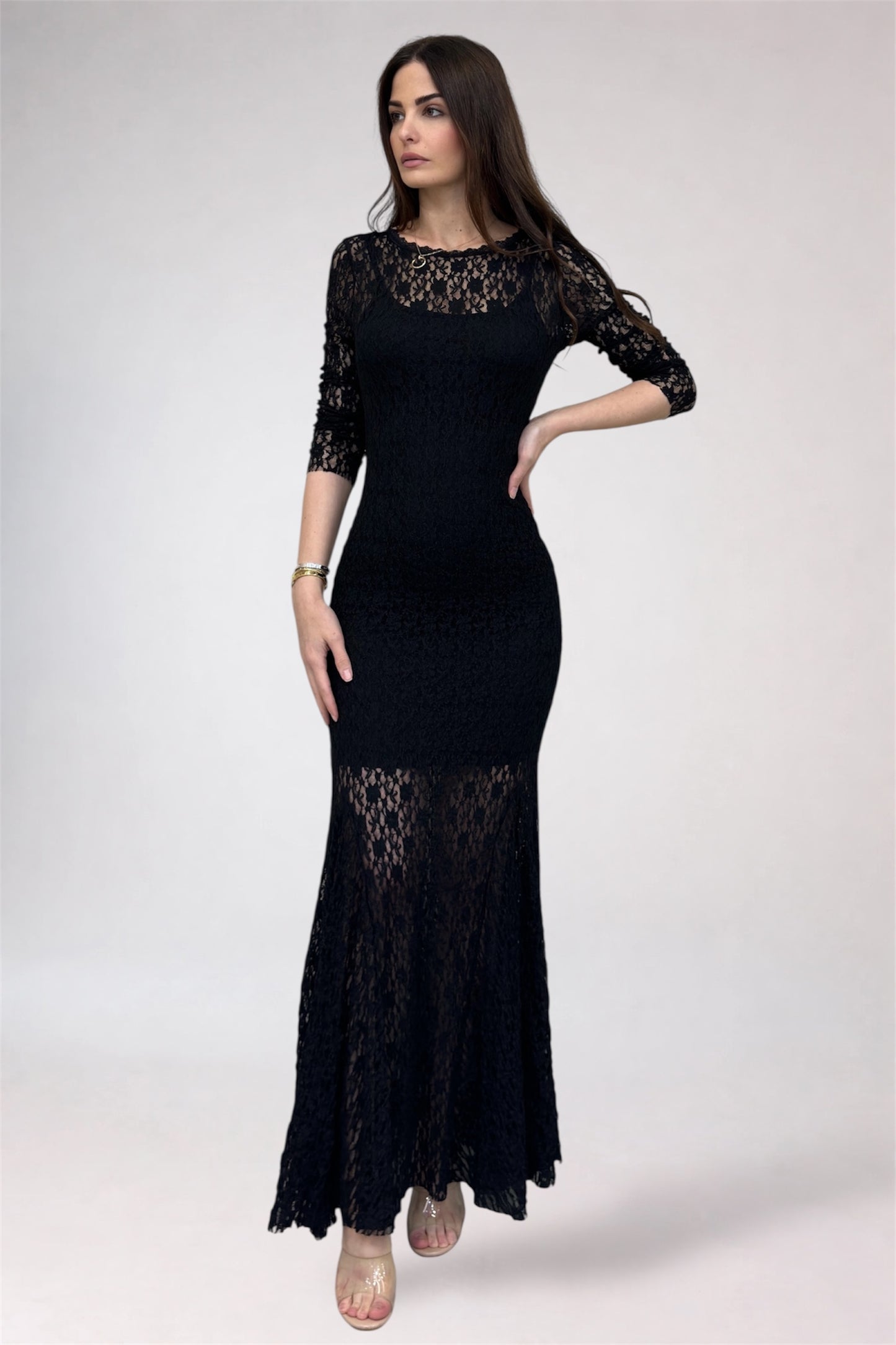 Woman wearing a black lace dress on a white background