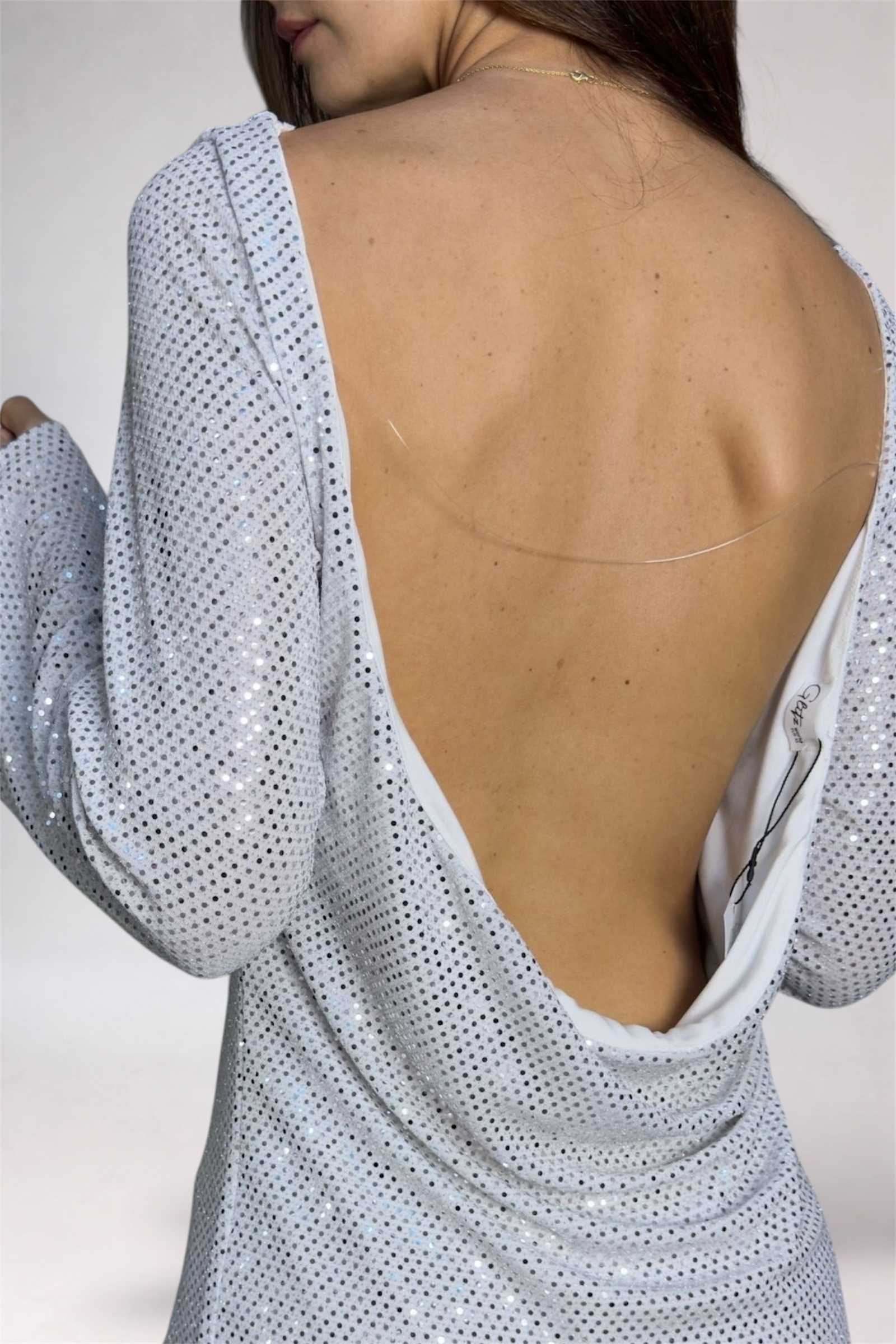 Light blue dress with open back on a plain background