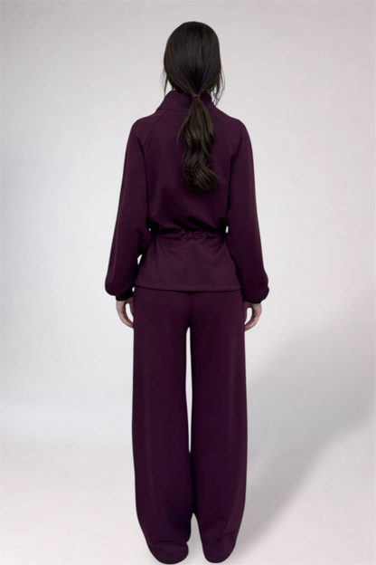 Person wearing a purple outfit on a white background