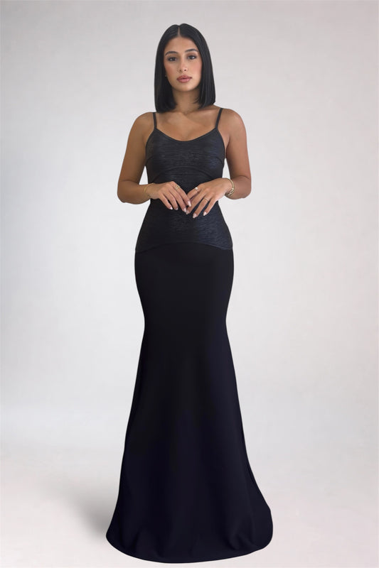 Woman wearing a black evening gown on a white background