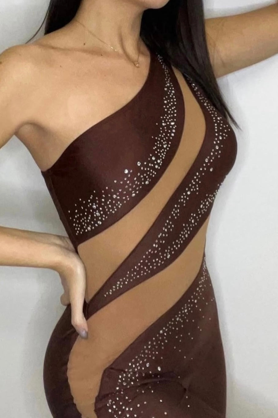 Brown dress with rhinestone details on a white background