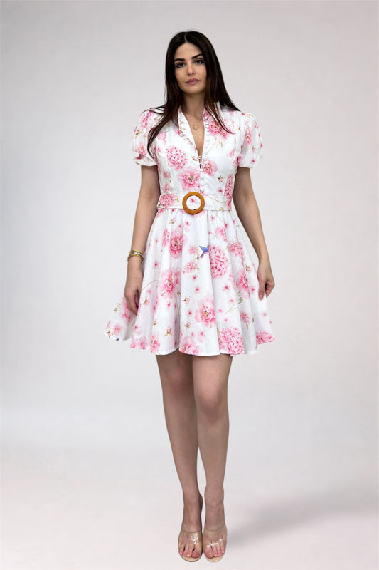 Woman wearing a floral dress with a belt on a white background