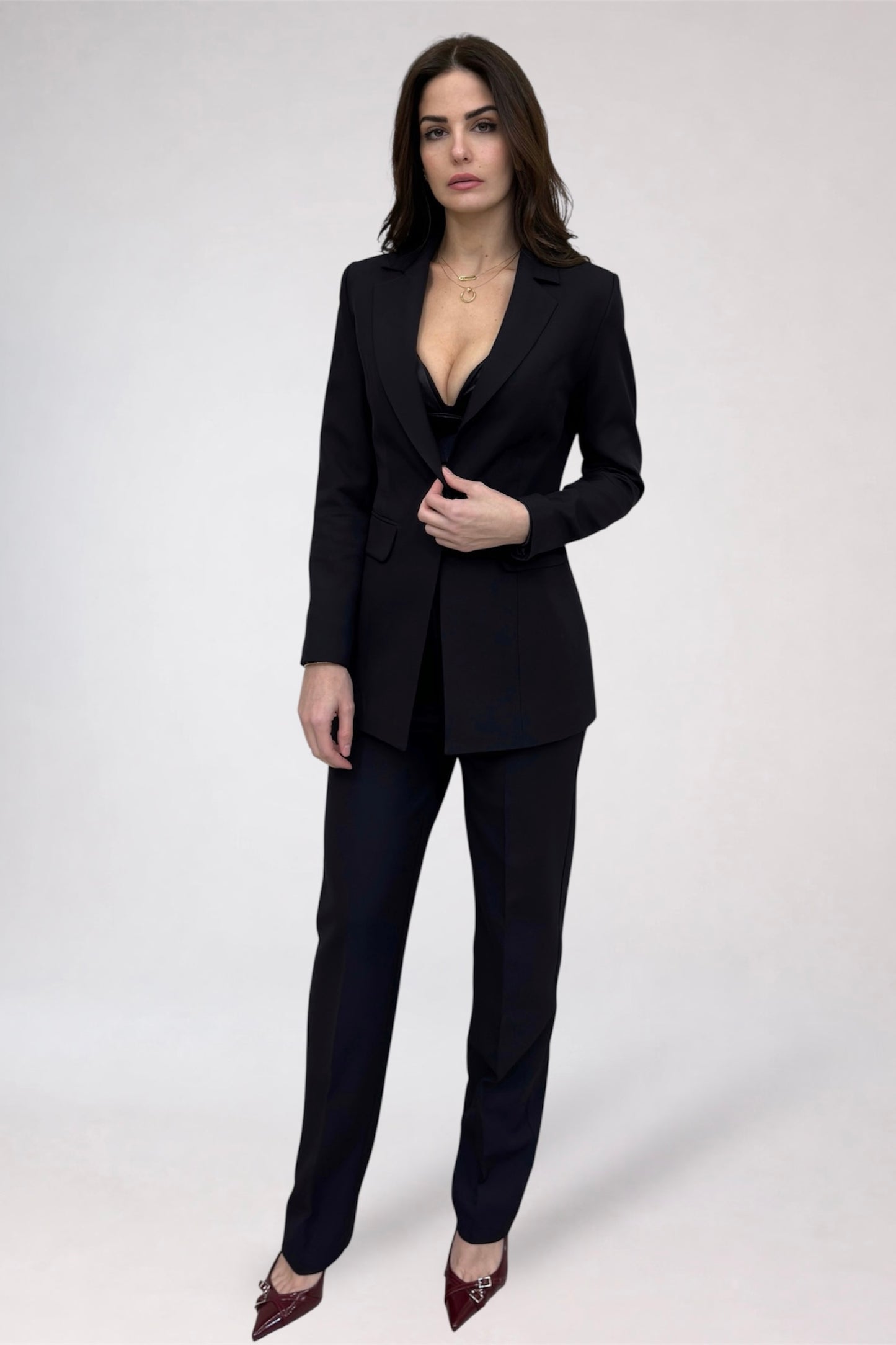 Woman wearing a black suit on a white background