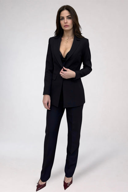 Woman wearing a black suit on a white background