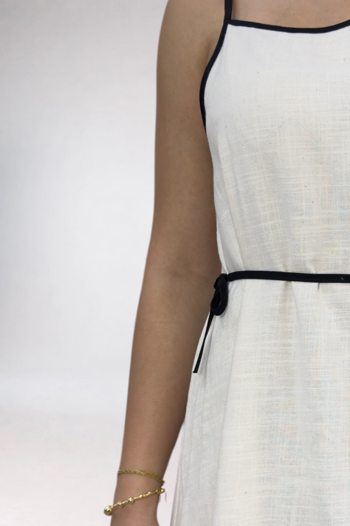 White dress with black straps on a white background