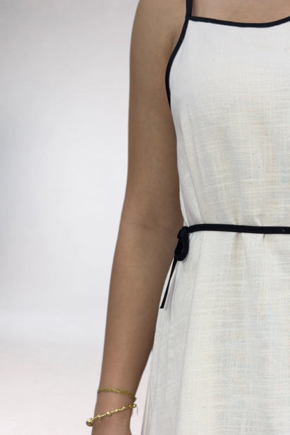 White dress with black straps on a white background
