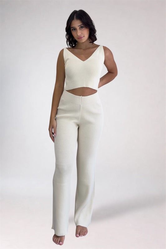 Woman wearing a white outfit on a plain background
