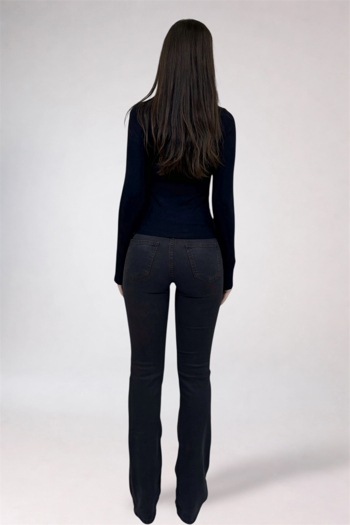 Person wearing a black outfit on a white background