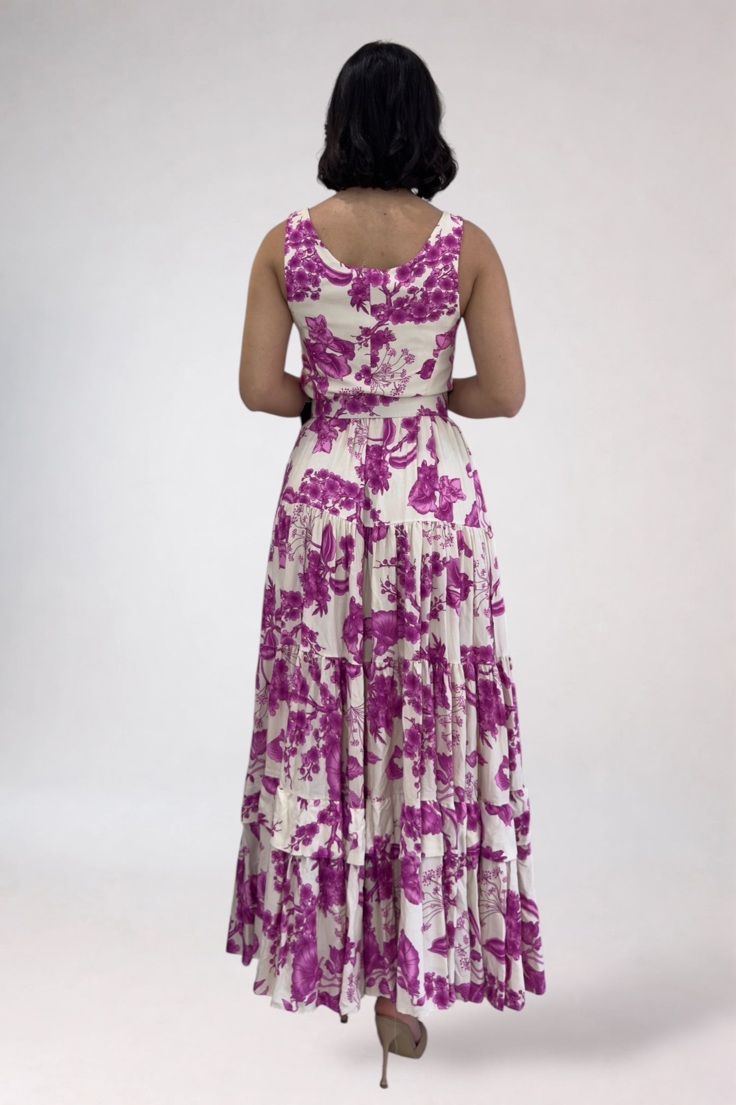 Woman wearing a purple floral dress on a white background