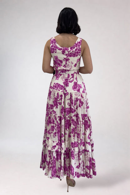 Woman wearing a purple floral dress on a white background