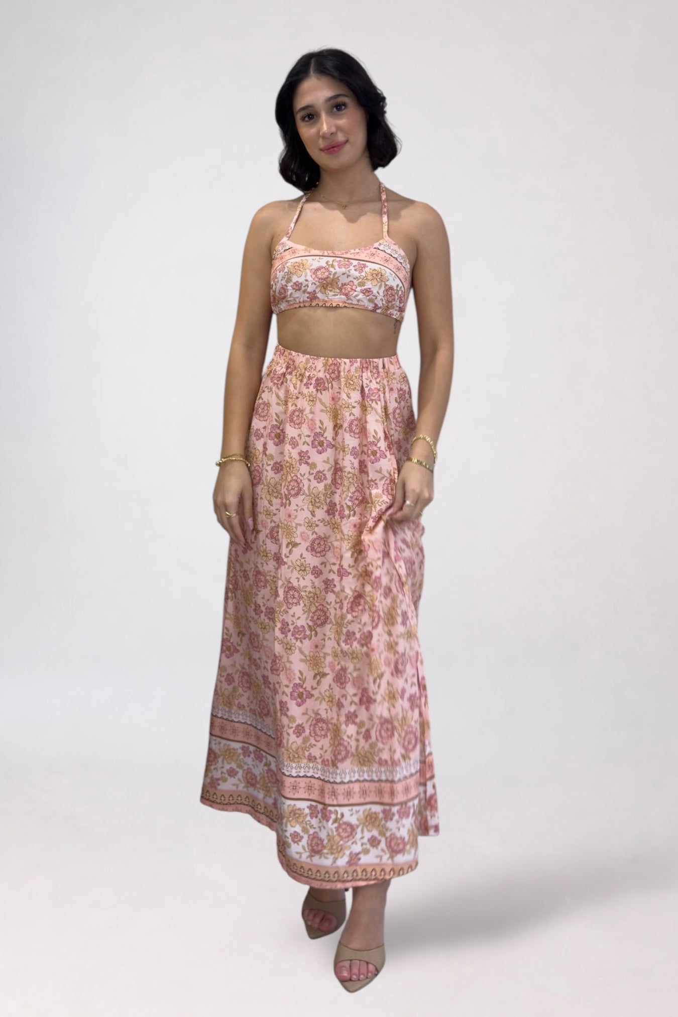 Woman wearing a floral two-piece outfit on a white background