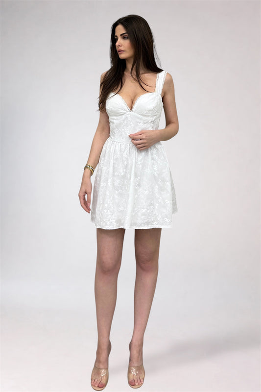 Woman wearing a white dress on a plain background