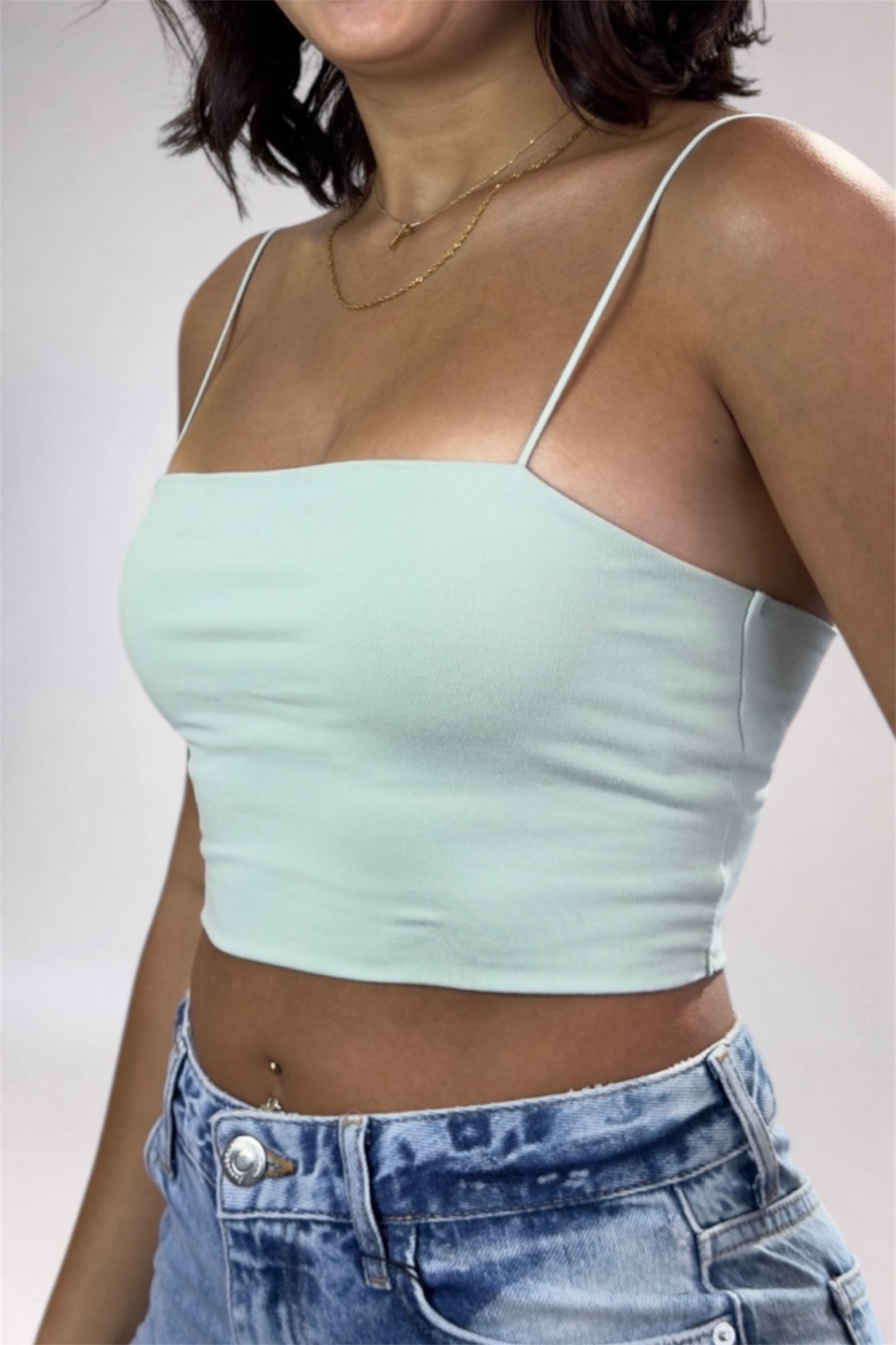 Light green crop top worn by a person against a neutral background