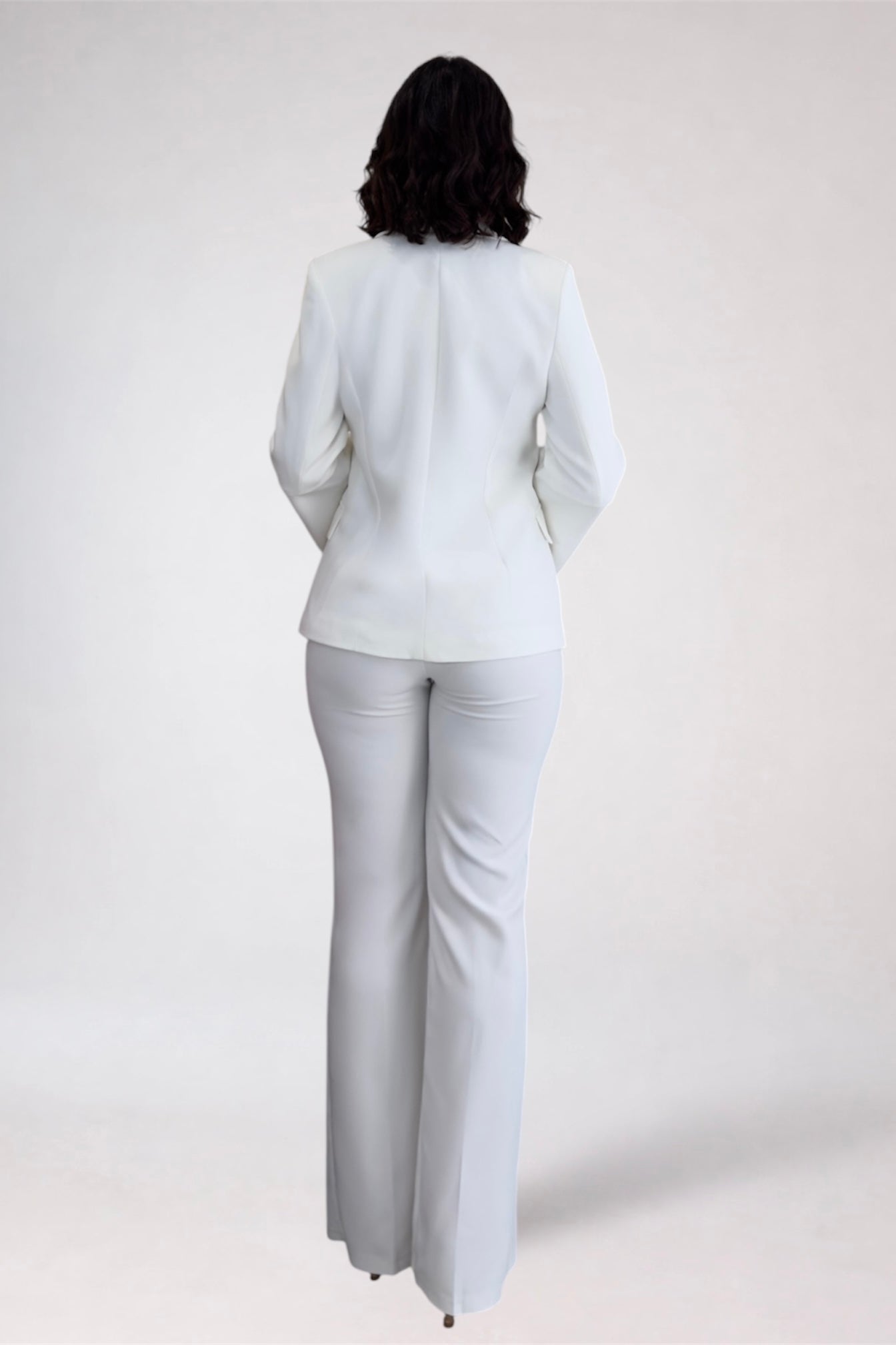 Person wearing a light gray suit on a white background