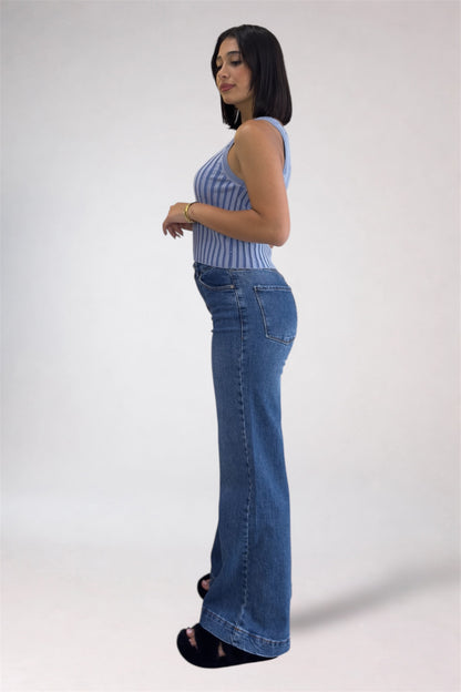 Woman wearing a striped top and blue jeans on a white background